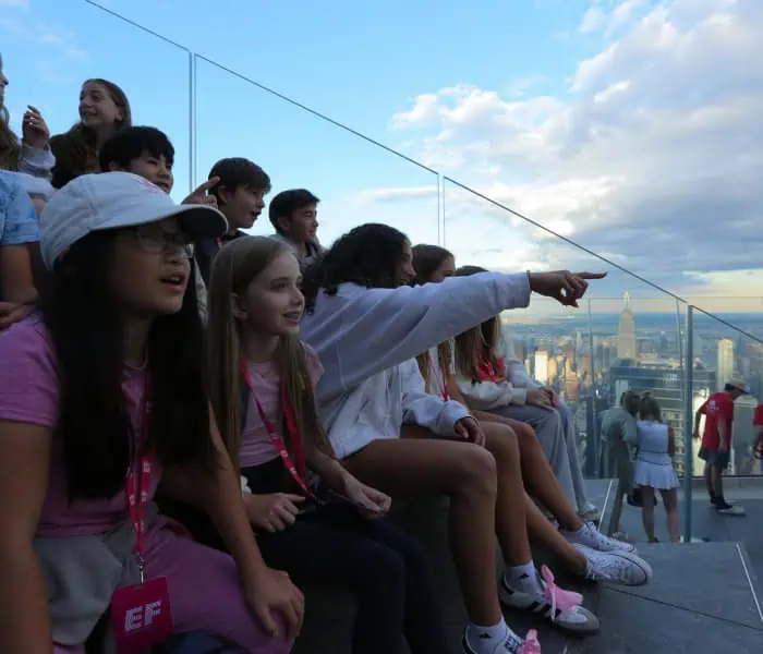 Group of kids on the Edge steps overlooking the city views