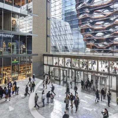 The interior of Hudson Yards shops, floor to ceiling windows overlooking Vessel