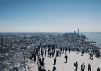 a group of people looking at NYC skyline during the day from The Edge NYC