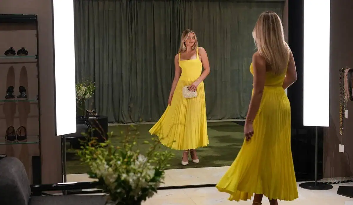 woman posing infront of mirror in yellow dress