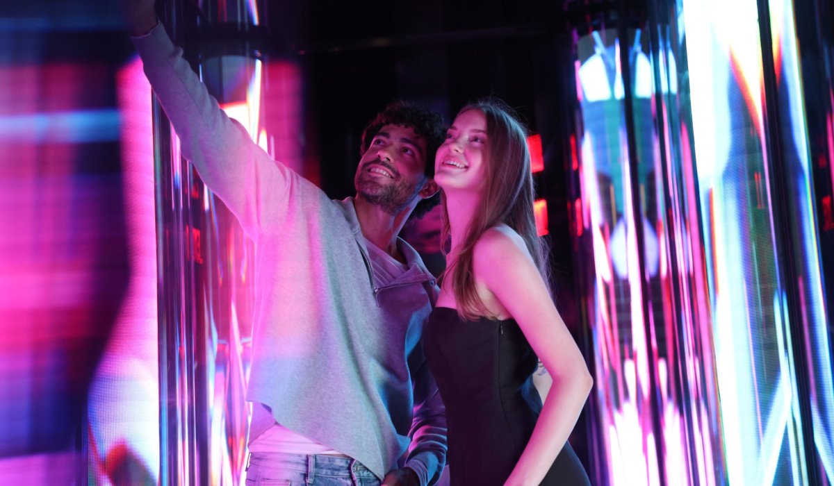Guests experiencing immersive indoor installations at Edge NYC with reflective lighting effects.