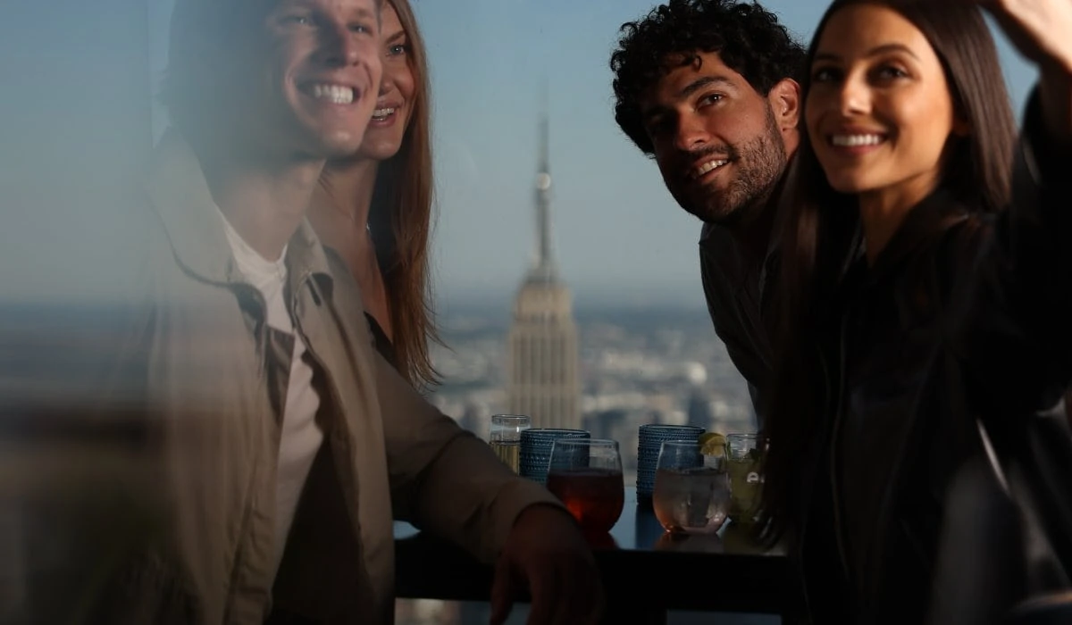 Visitors at Edge NYC during daytime with Manhattan skyline views.