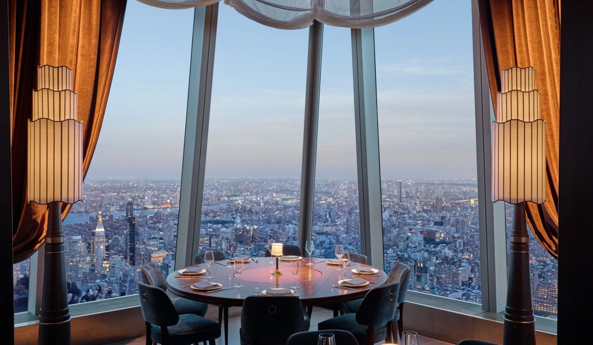 Elegant dining setup with panoramic NYC skyline view from Edge NYC sky deck.