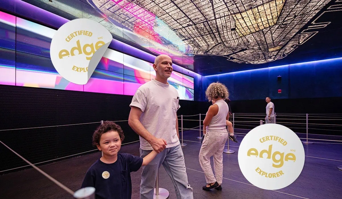 Visitors at Edge NYC indoor experience with colorful LED displays and signage.