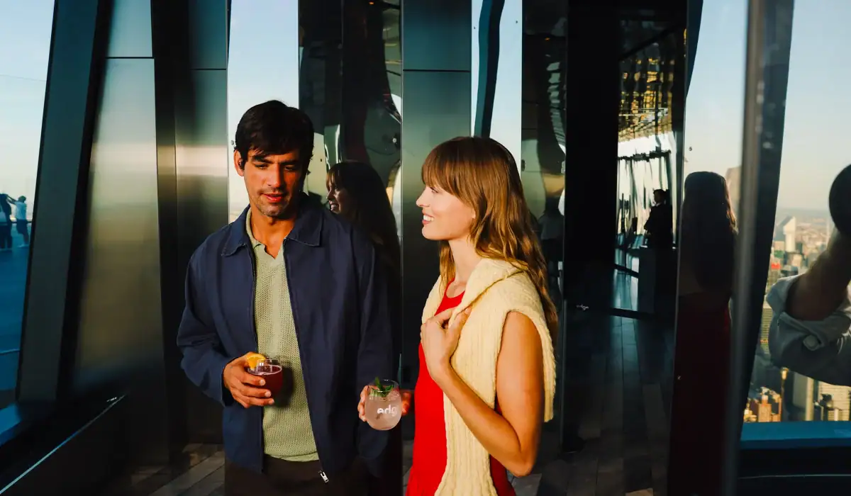 Two Friends with Drinks at Infinite City: Immersive Experience at Edge