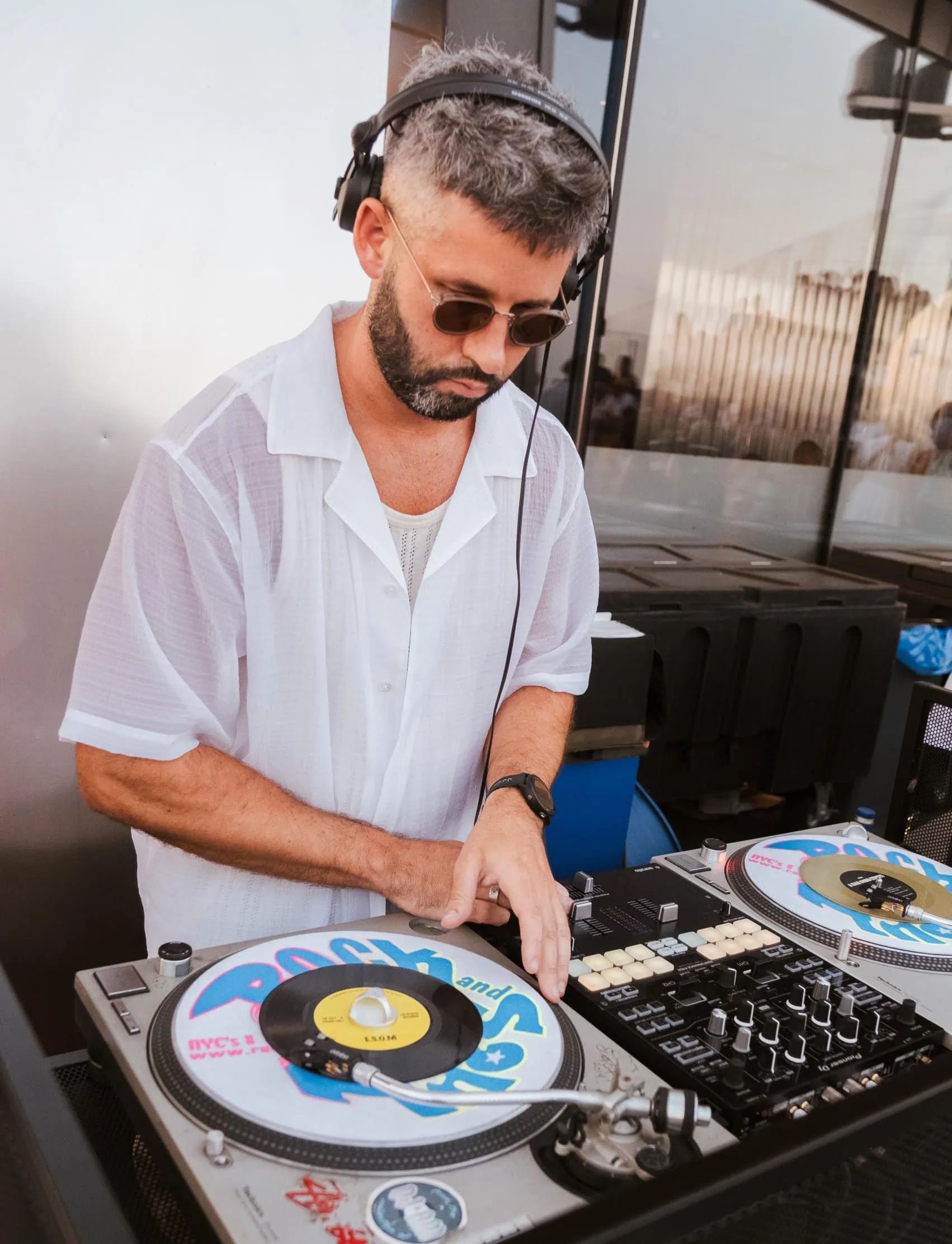 DJ playing music at Edge NYC outdoor sky deck with skyline view.