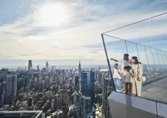 Visitors enjoy panoramic views from Edge NYC sky deck at Hudson Yards.