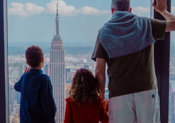 Family enjoying panoramic NYC skyline from Edge NYC sky deck.