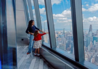 Family enjoying panoramic city views from Edge NYC sky deck at Hudson Yards.