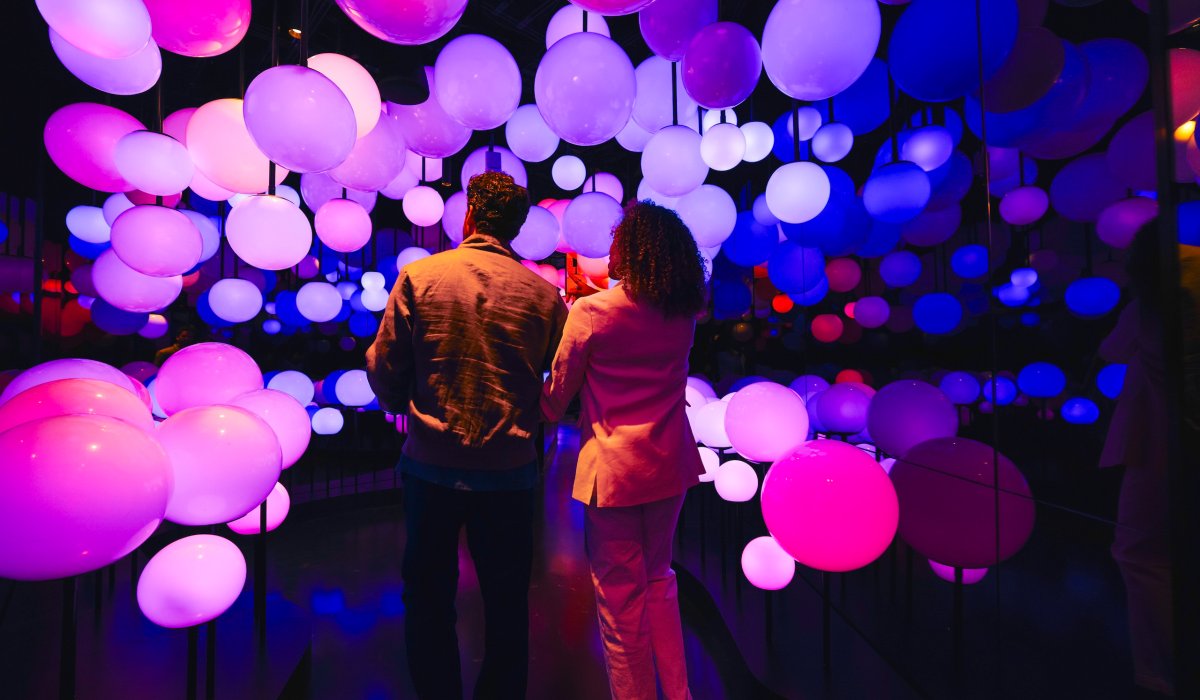 Couple enjoying colorful illuminated immersive installation at Edge NYC.