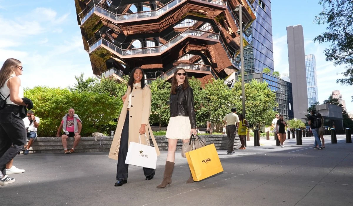 Two women with shopping bags outside of Vessel at Hudson Yards.