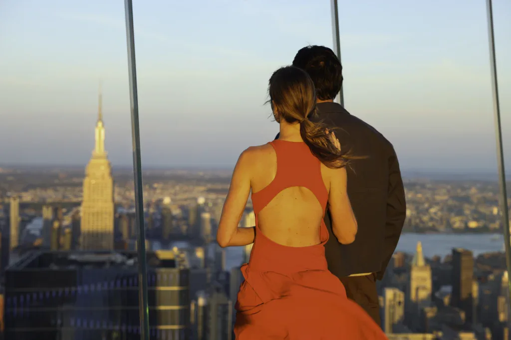 Edge NYC Sky Deck View at Sunset - Edge NYC - Edge NYC Couple enjoying panoramic skyline view from Edge NYC sky deck at sunset.